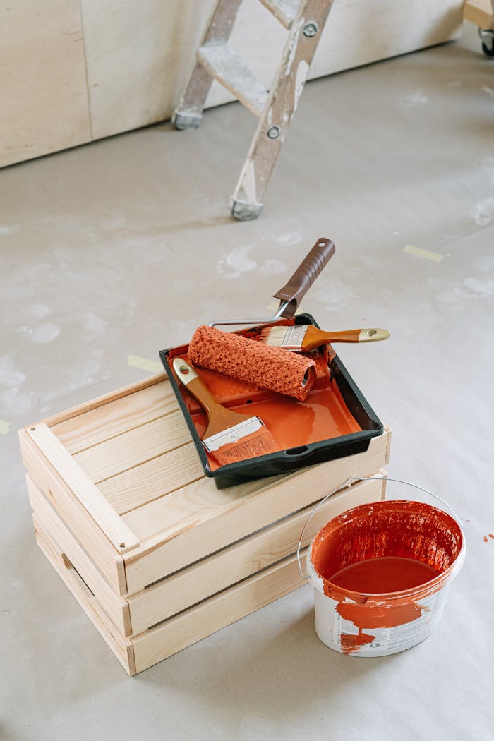 Crafting Captivating Headlines: Your awesome post title goes here A close-up of home renovation tools including paint roller and red paint bucket on a wooden crate.